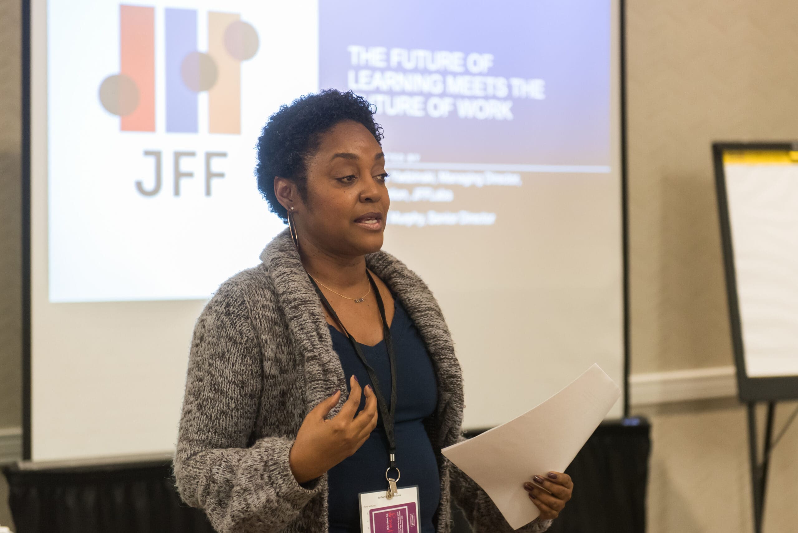 A woman gives a presentation titled 