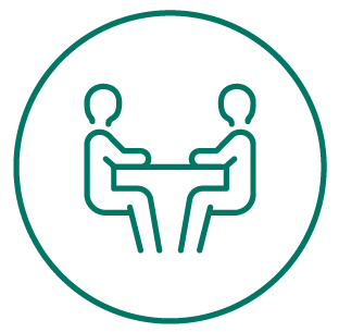 Icon of two people sitting at a table, facing each other, within a circular border.