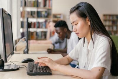 People drawing inspiration from the library's quiet corners, working diligently on their computers.