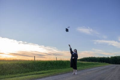Graduate cap throw on rural road