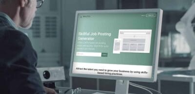 Person using the job posting generator tool on a monitor