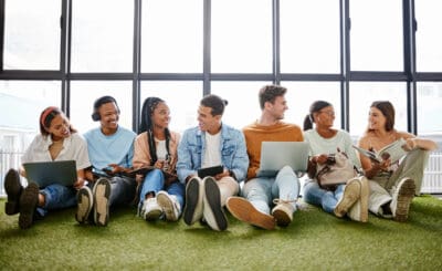 Teamwork, friends and technology with business people working as a team together on creative or design. Collaboration, diversity and startup with a young small business owner group in their office