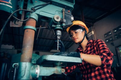 Asian beuatiful woman working with machine in the factory engineer and working woman concept or woman day