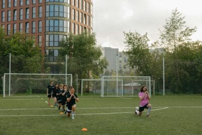 A group of athletes training on a soccer field.