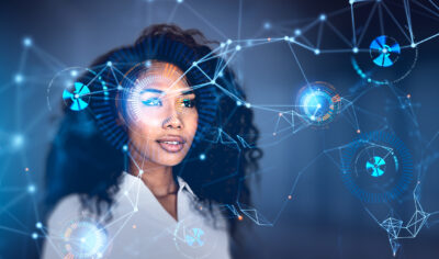 A woman looks forward with digital graphic overlays of interconnected networks, data points, and circular interface elements in a futuristic technology concept.