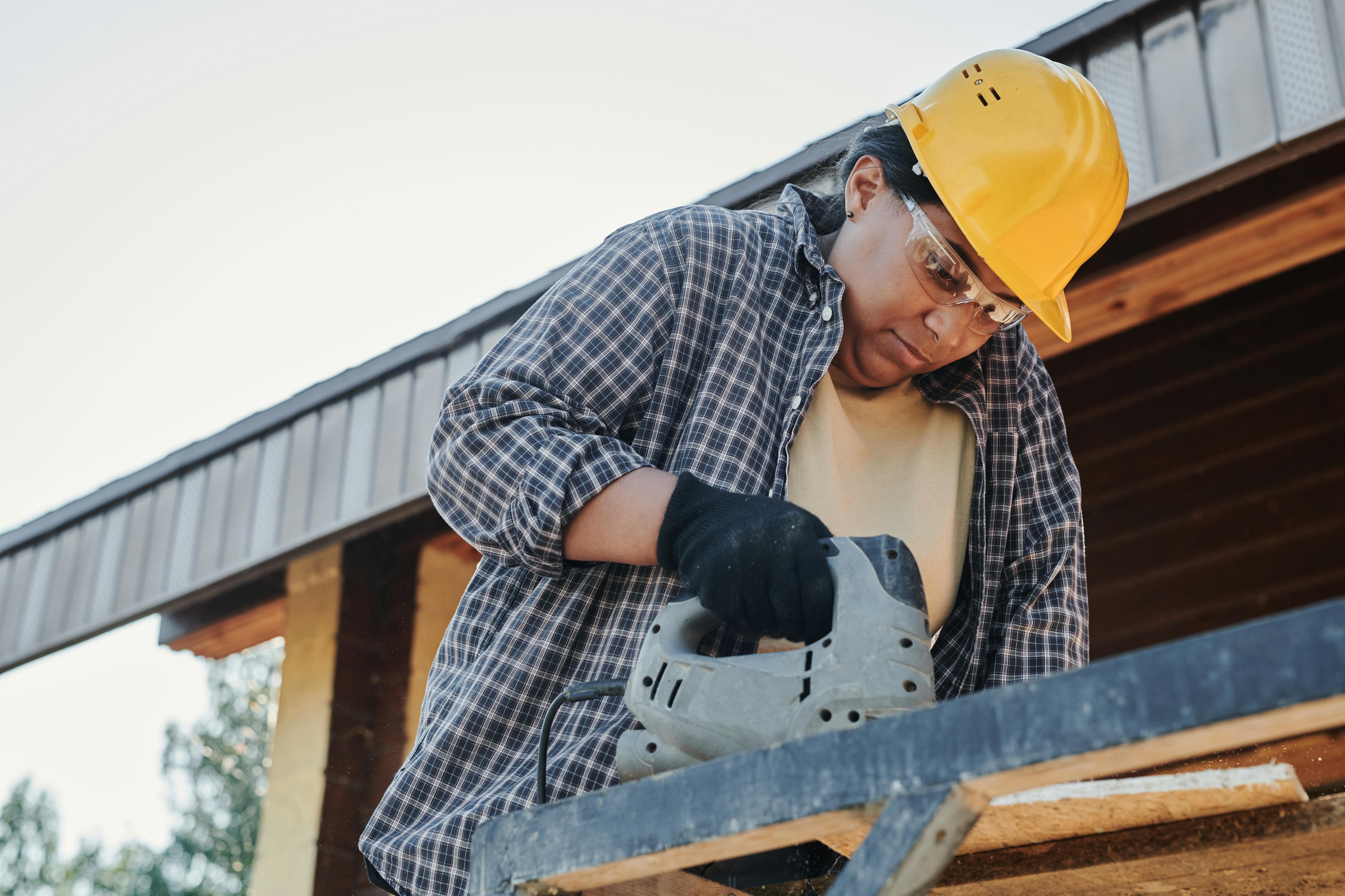Woman in Yellow Hard Hat and Black and White Plaid Dress Shirt