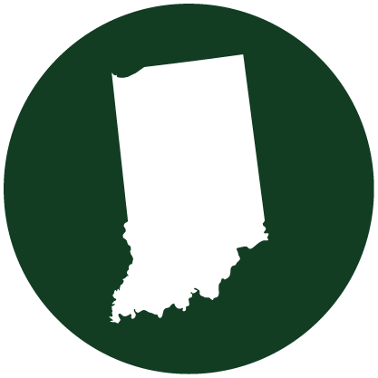 A white silhouette of the state of Indiana centered on a dark green circular background.