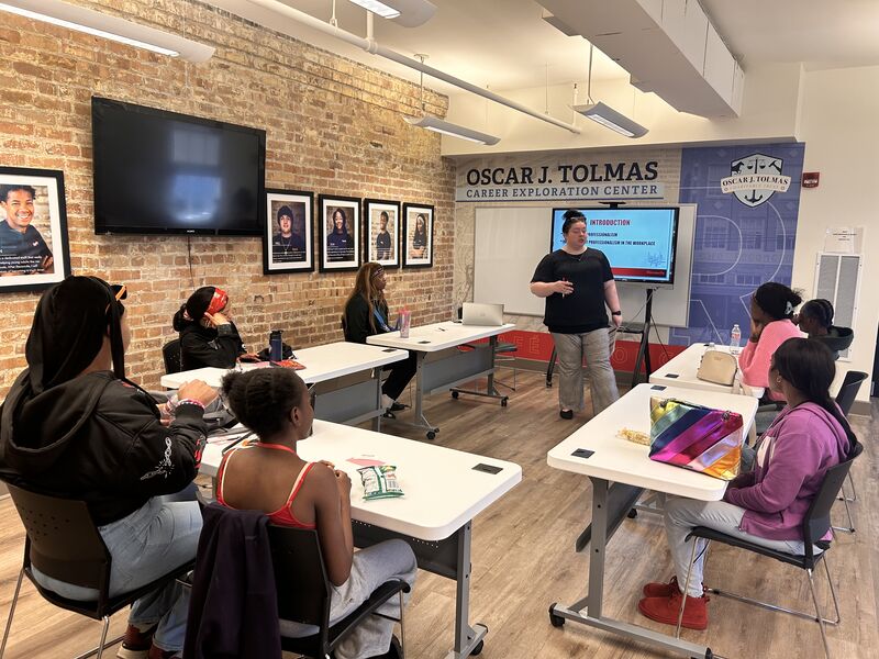 A teacher stands at the front of a classroom speaking to students seated at desks in the Oscar J. Tolmas Career Exploration Center.