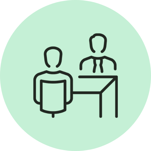 Simple line drawing of two people sitting across a desk from each other, one wearing a tie.